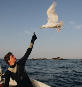 man feeding bird