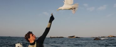 man feeding bird